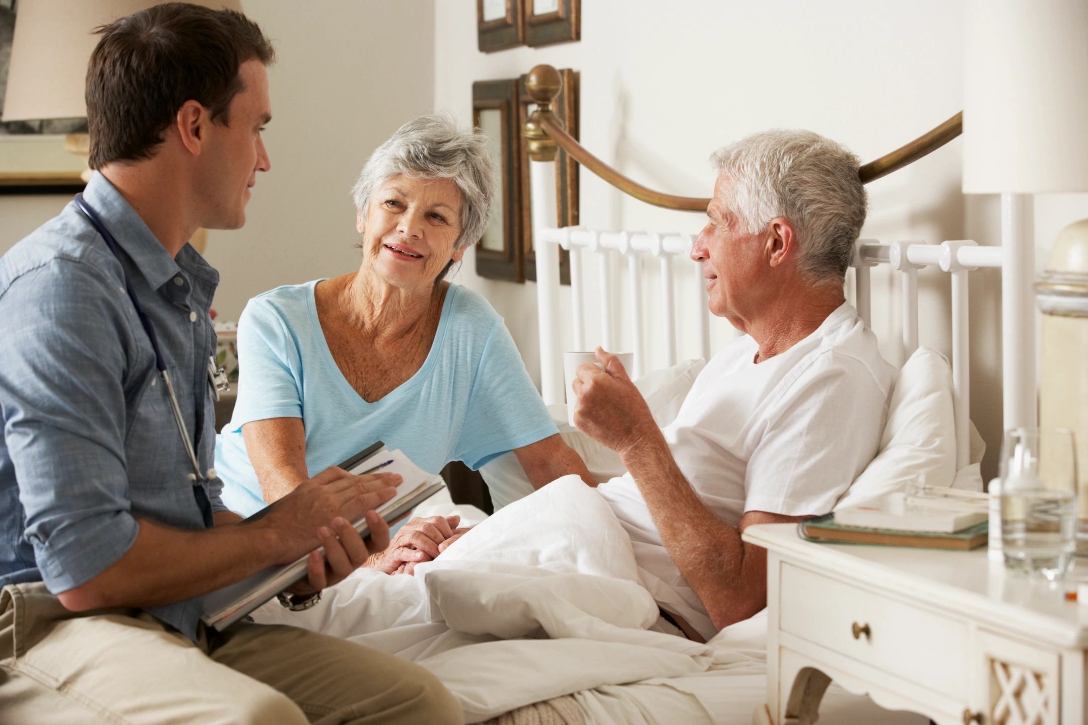 Healthcare professional consulting with elderly couple